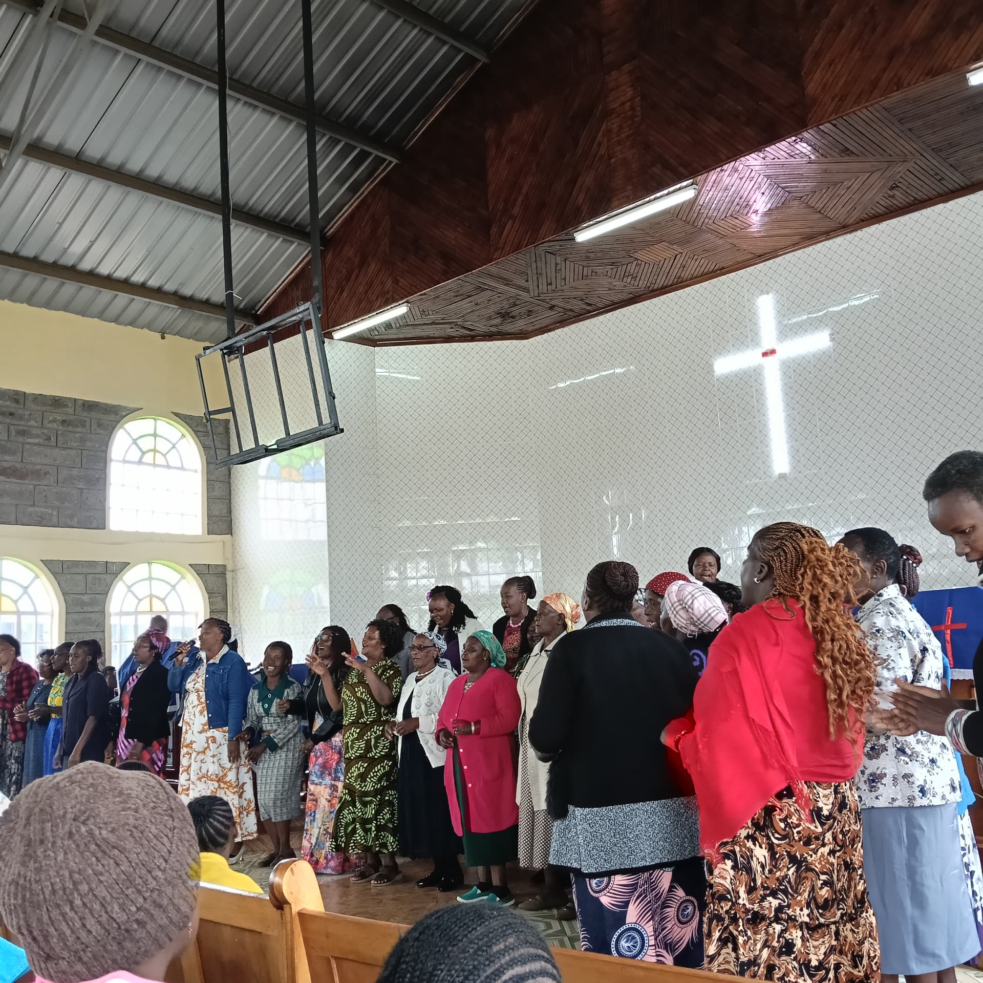 Kagaa Parish women's choir singing during an AYHEM community gathering